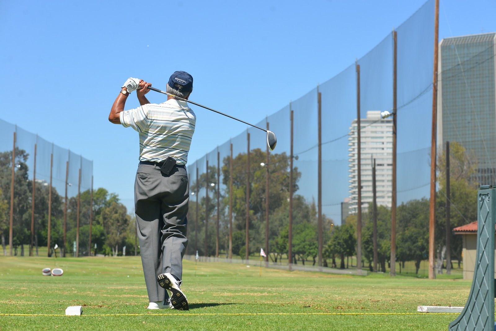 senior golfer practicing